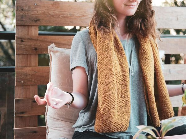 Person meditatively exercising in a glow violet light